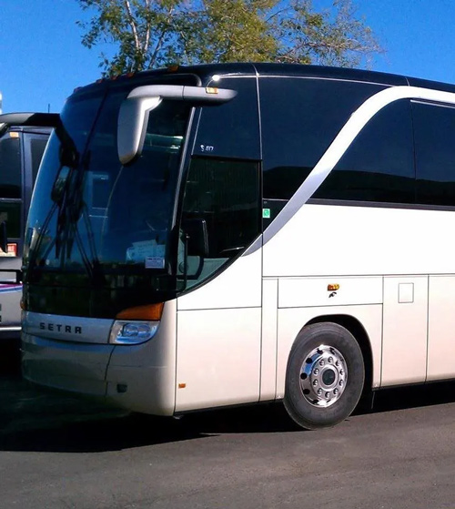 A white bus parked in a Virginia lot for corporate transportation