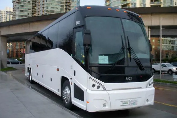 A white bus in a Maryland lot for group transportation services