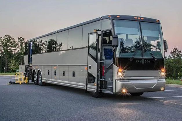 A large bus parked on a roadside for group charters