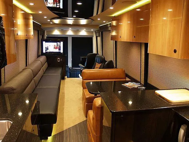 A living room setup with a TV showcasing bus rental services