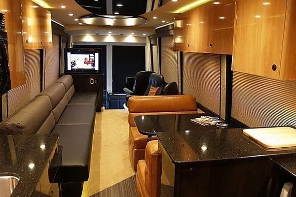 A living room setup with a TV showcasing bus rental services