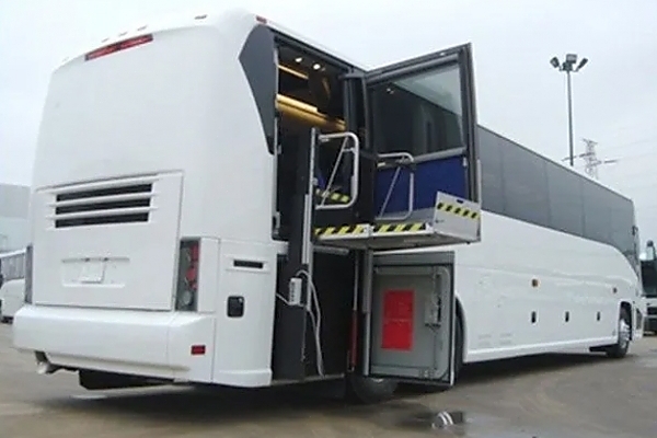 A large white bus available for rent in a Virginia parking lot