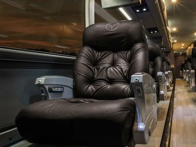 A black leather chair in a luxury bus rental