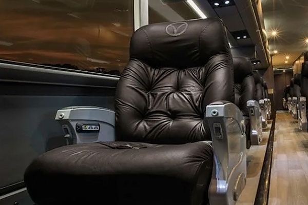 A black leather chair in a luxury bus rental