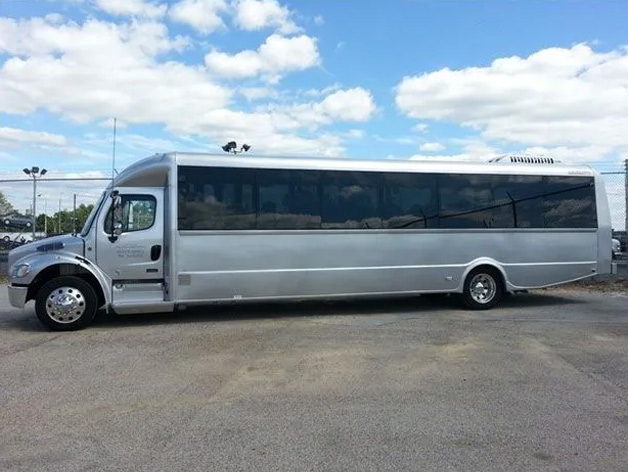 A white bus in a spacious Virginia parking lot for charter services