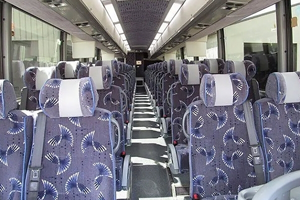 A row of seats featuring blue and white stripes on a bus rental