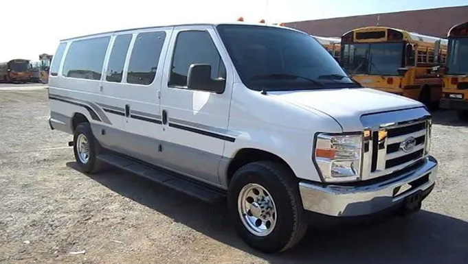 A white bus parked in a Virginia parking lot for rental services