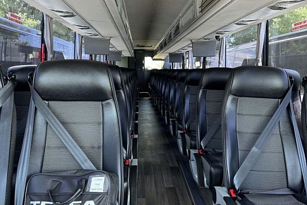 A bus with many seats designed for large group travel