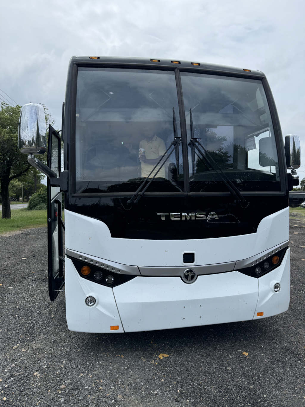 A white bus in a Chicago parking lot for charter services