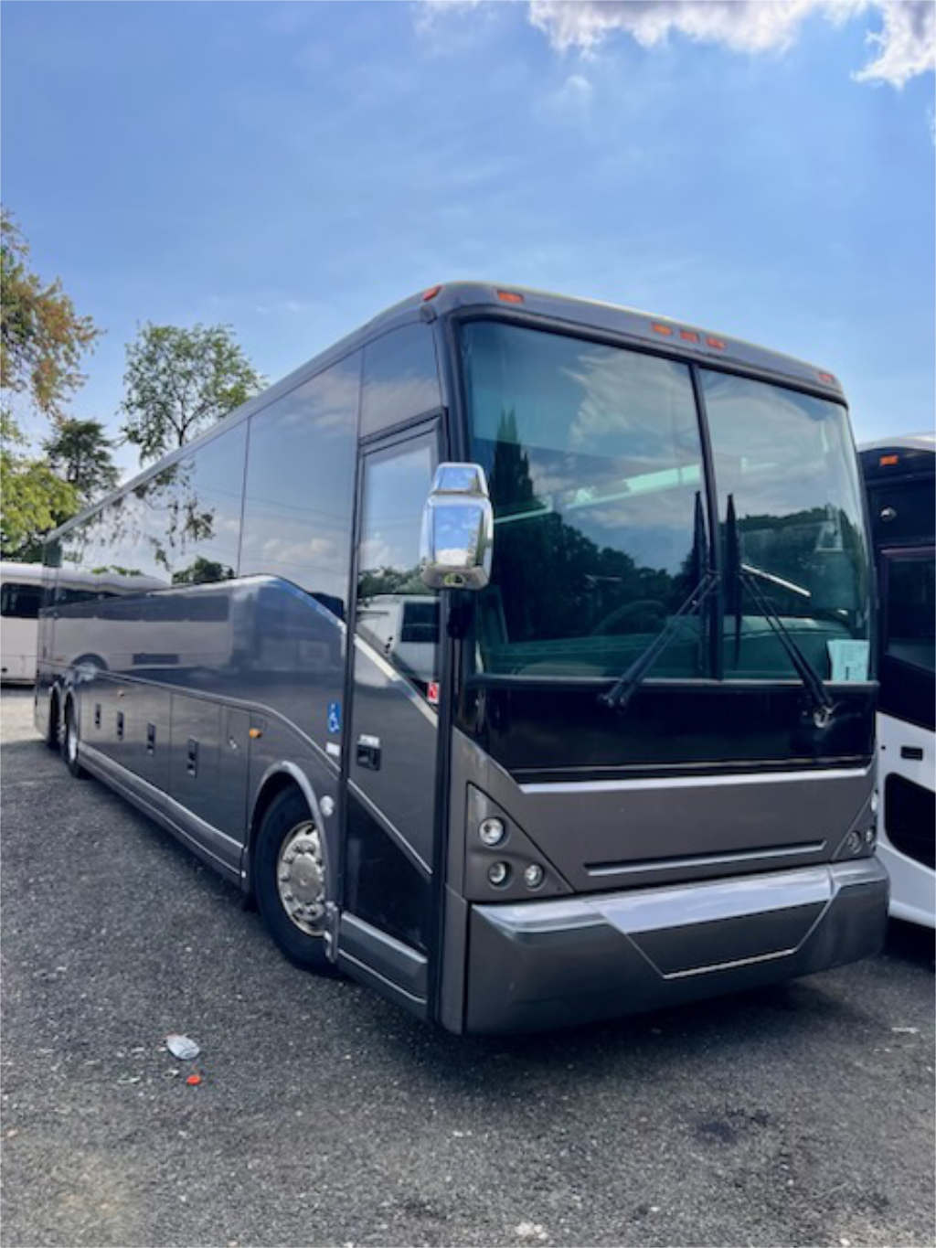 A large bus parked in a scenic lot for tours