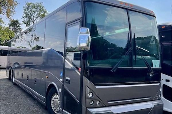 A large bus stationed in a New Jersey parking area for charters