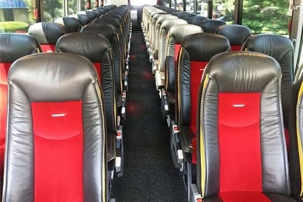 A row of seats with different colors on a minibus rental