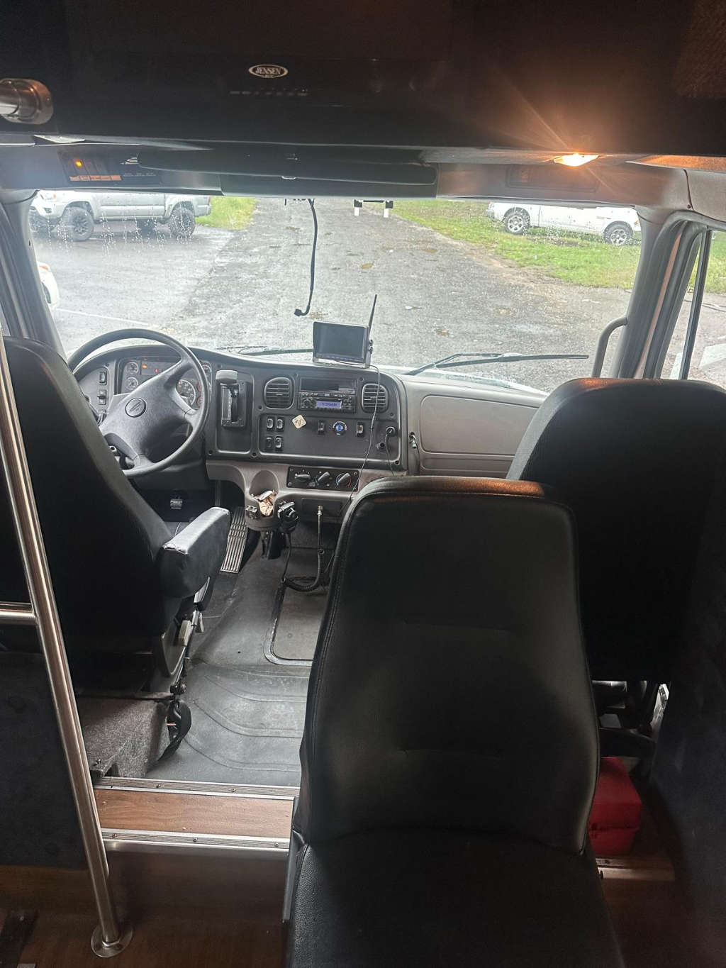 A row of seats on a bus with large windows for scenic travel