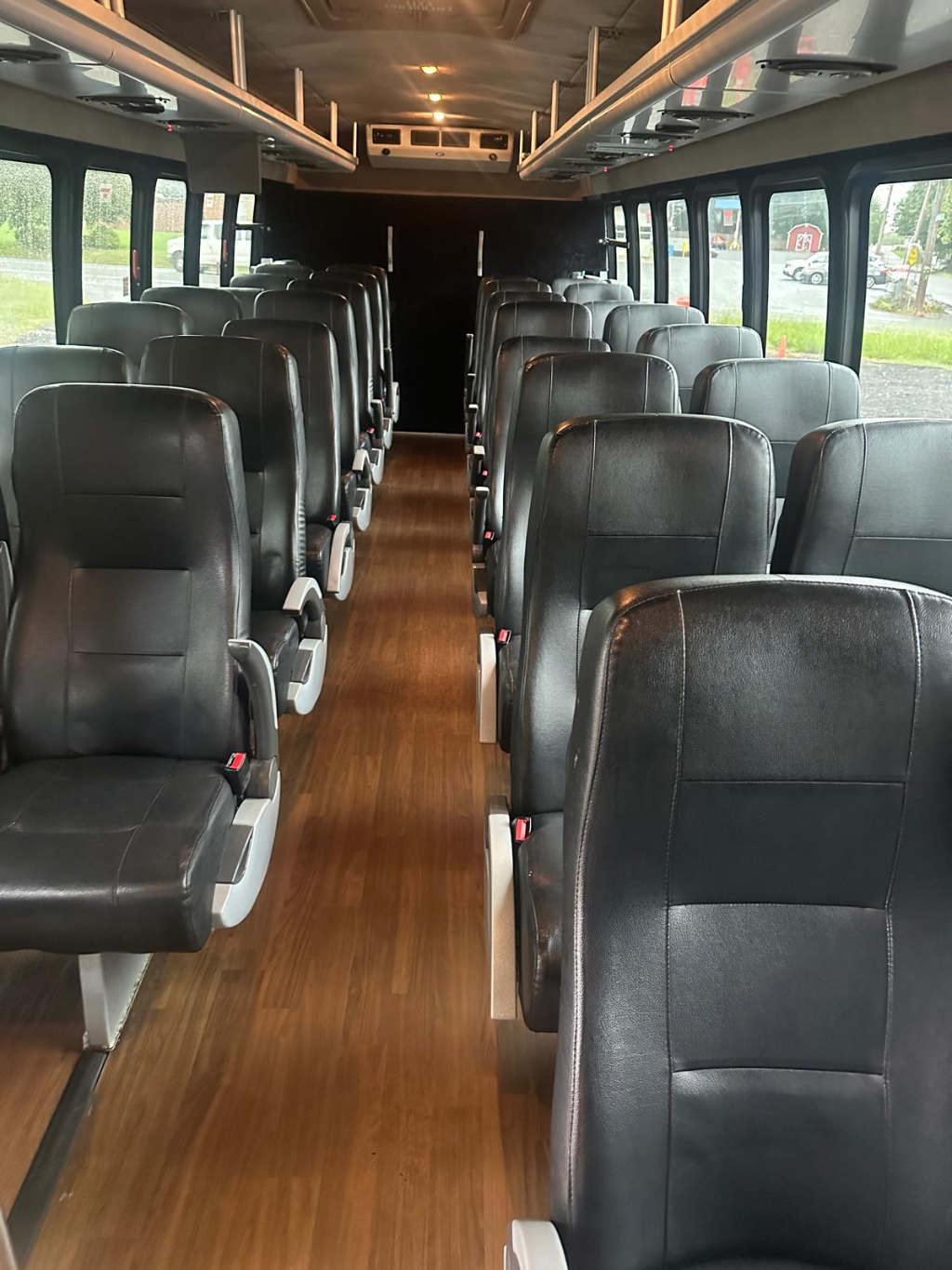 A row of seats on a bus with large windows for scenic travel