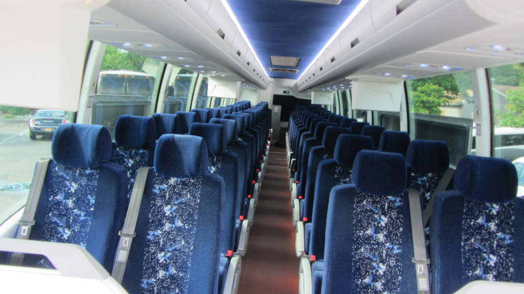 A row of seats with blue and white patterns on a minibus