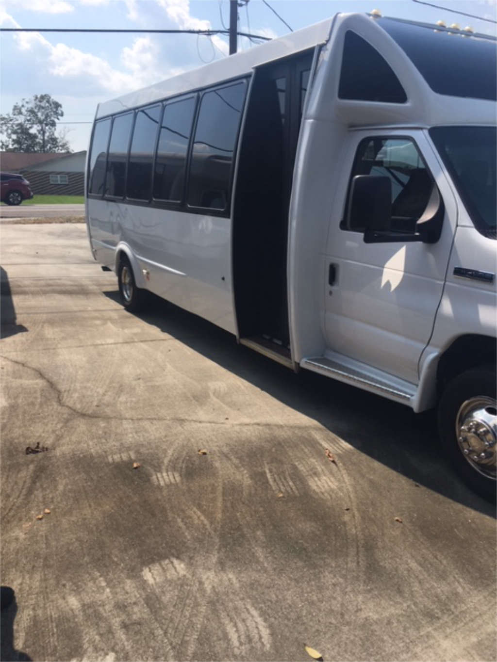 A white bus parked in a Virginia lot for long-distance services