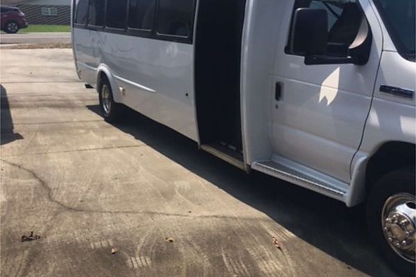 A white bus parked in a Virginia lot for long-distance services