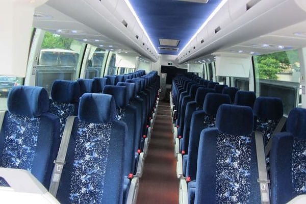 A row of seats with blue and white patterns on a minibus